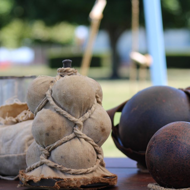 Various kinds of cannon ammunition on a table.
