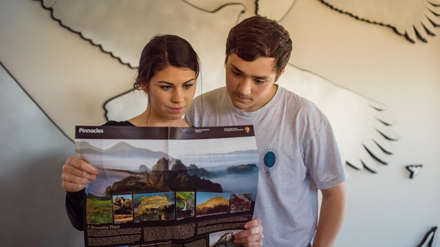 Visitors consult a park map.