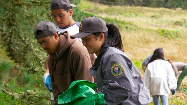 Group of young adults picking up trash at a volunteer event