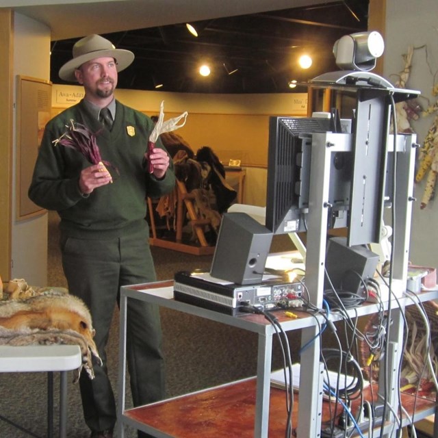 Ranger holding up props in front of a computer webcam