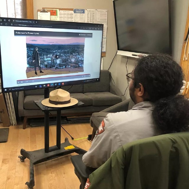 Ranger holding up props in front of a computer webcam