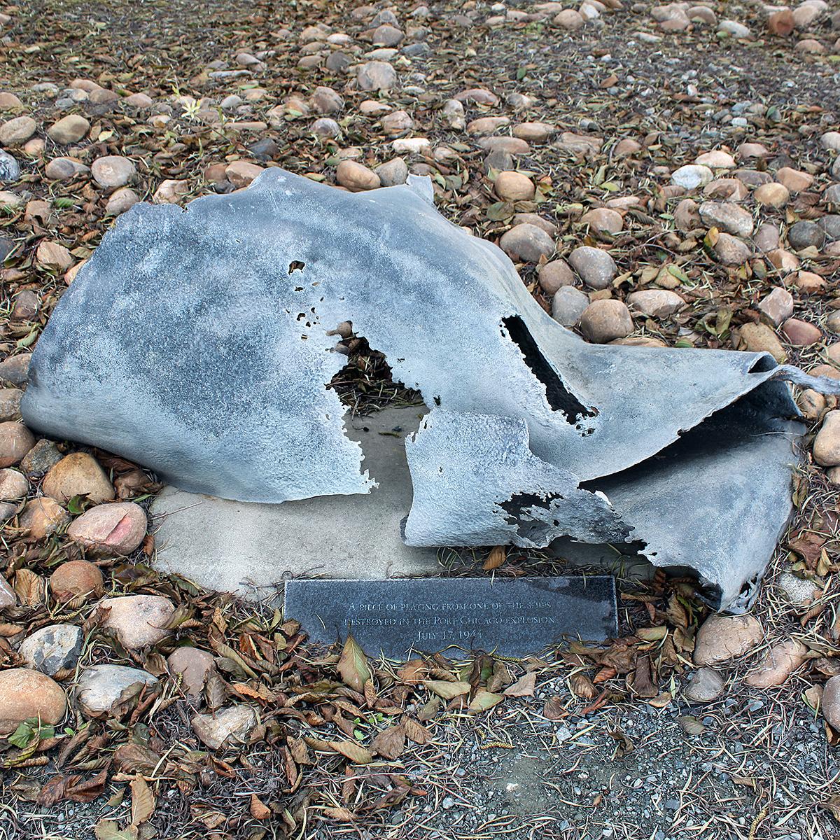 A small piece of ship metal debris is installed in the ground, as an exhibit. 