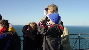 A group of visitors watching for gray whales.