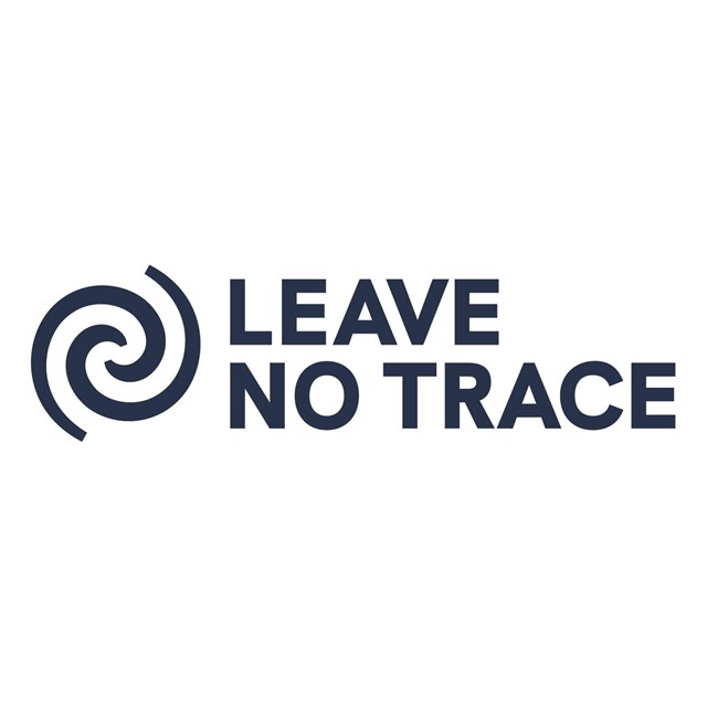Two curved dark gray lines in a spiral pattern next to the words Leave No Trace.