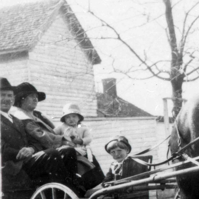 The Taylor Family being pulled by a horse carriage 