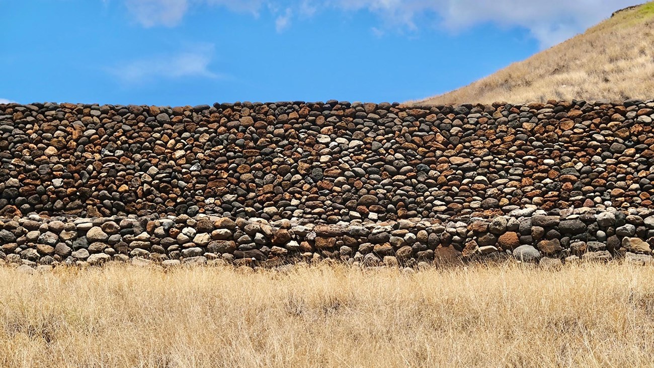 Rock wall at the base of a hill