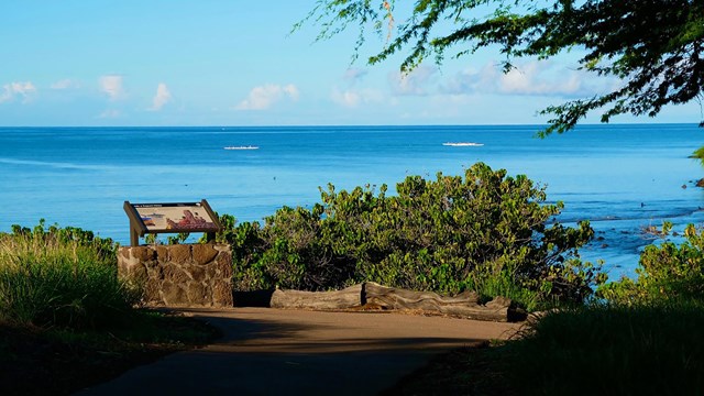 Wayside interpretive sign overlooking ocean bay
