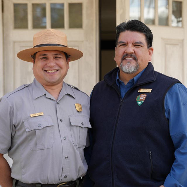 A ranger stands with the Director of the National Park Service.