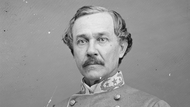 A black and white photograph of a middle-aged man in a Confederate military uniform