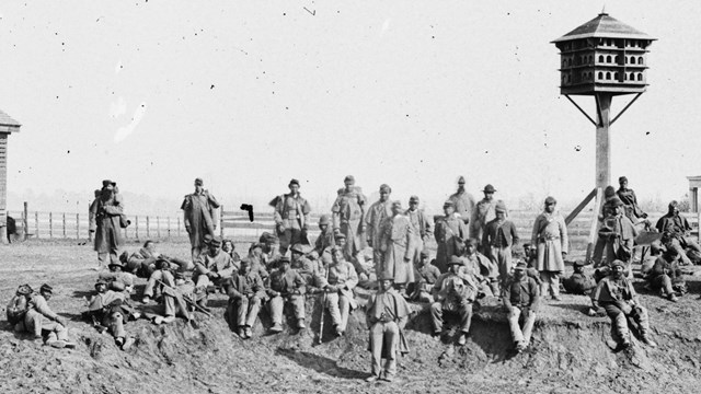 a black and white photograph of a group of uniformed African American Civil War soldiers.