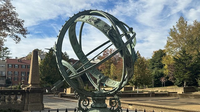 an armillary sphere with a fence around it