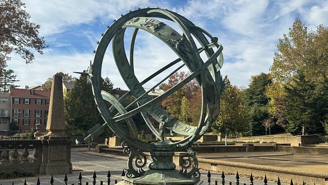 an armillary sphere surround by a fence