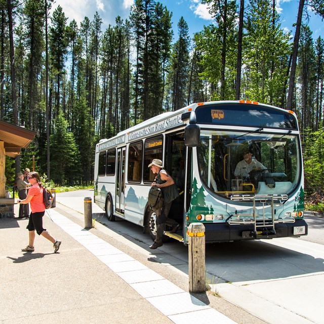 a person disembarks a bus that reads 