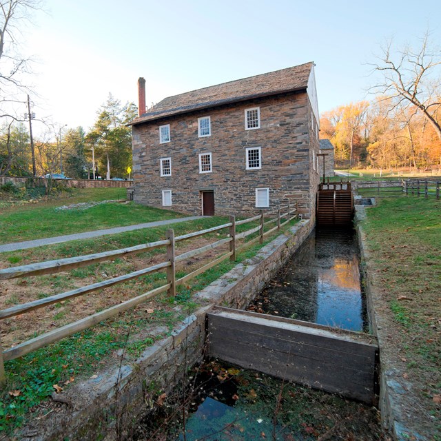 Peirce Mill from behind, the water wheel trough leads up to the building. 