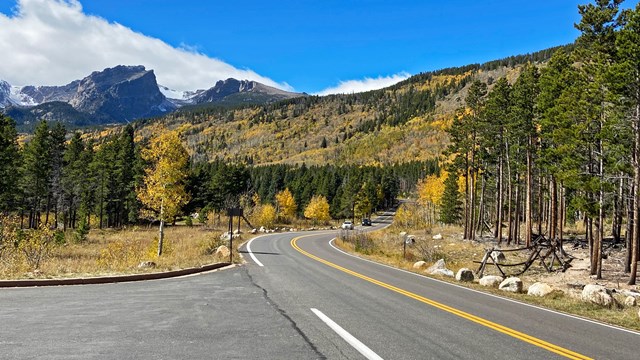 Fall along the Bear Lake Road. Aspen have golden leaves and snow is on the mountain tops.