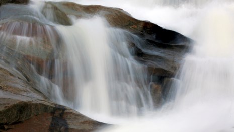 Water flows over rocks.