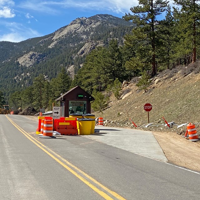 The Fall River Entrance to RMNP is under construction. Orange cones line the lane to the kiosk.