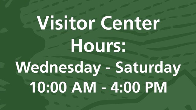 Green background with white text "Visitor Center Hours: Wednesday - Saturday 10:00 AM - 4:00 PM