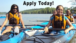 four youths in kayaks on water
