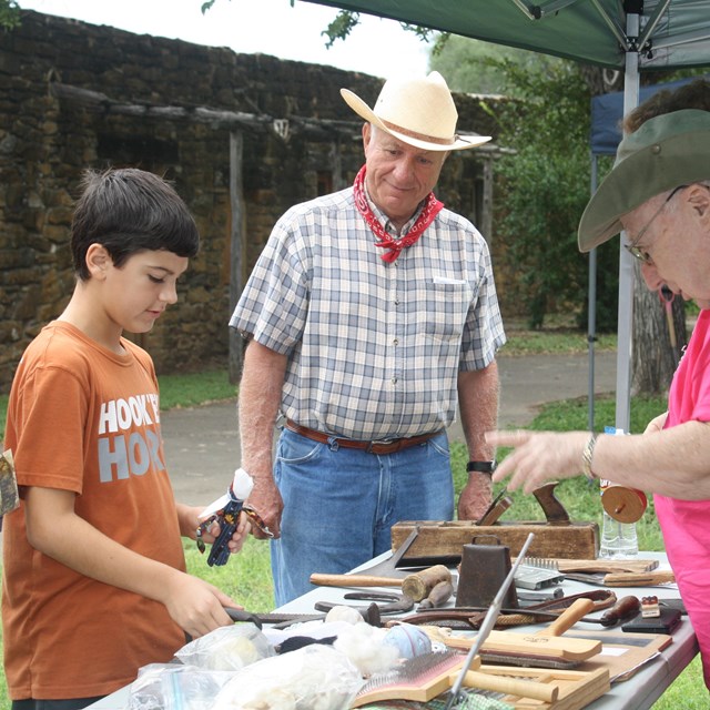 Volunteer speaks with youth at Archaeology Day
