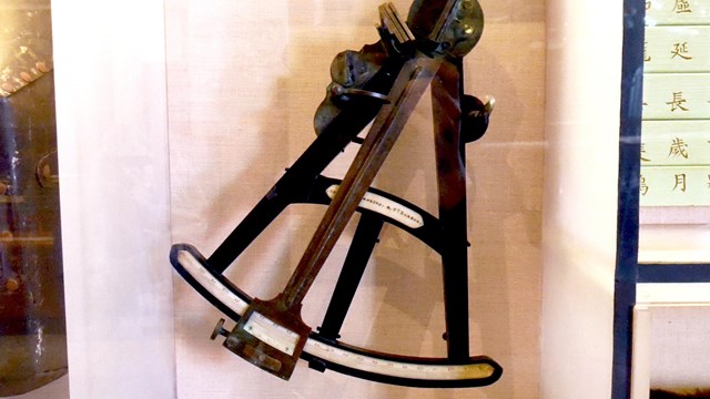 A navigation sextant sits on display.