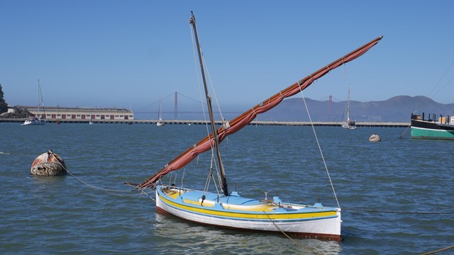 A felucca sailing boat sits in Aquatic Park Cove