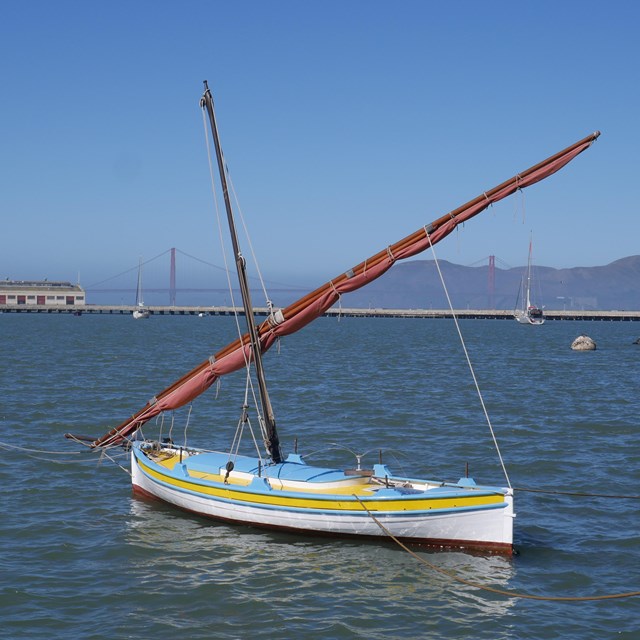 A felucca sailing boat sits in Aquatic Park Cove