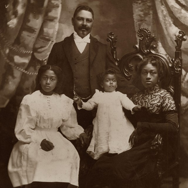 historic photo from 1886 of a wealthy black family posed for a portrait