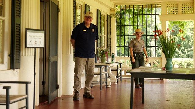 a volunteer and ranger on porch