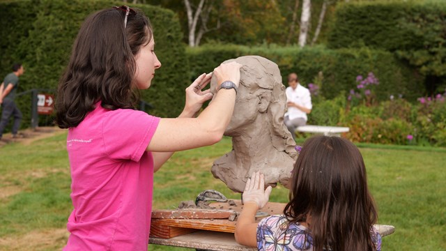 sculptor and child