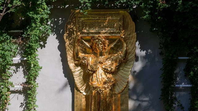 gilded sculpture of an angel in sunlight