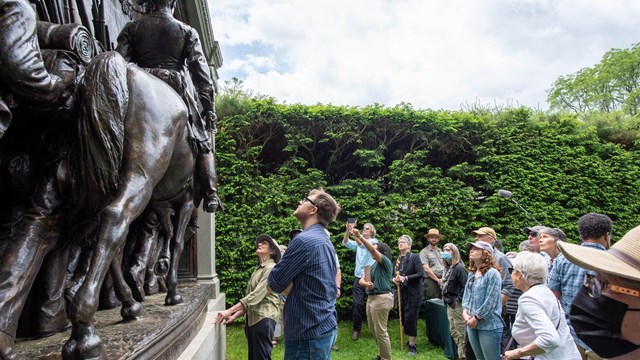visitors looking up at Civil War monument