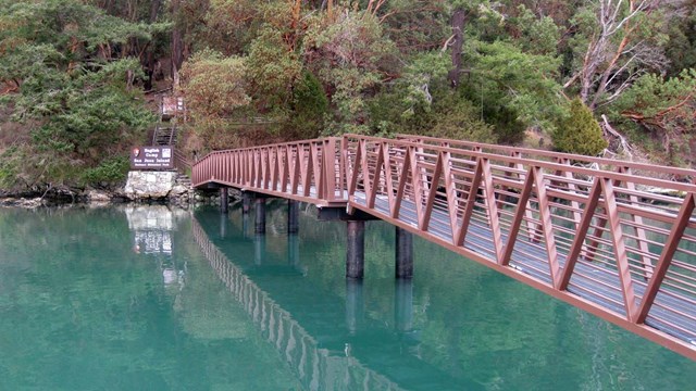 An elevated path above the water leads to stairs