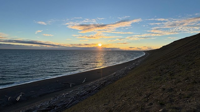 A sunset seen from the top of an ocean bluff.