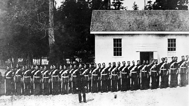 Black and white image of British soldiers lined up