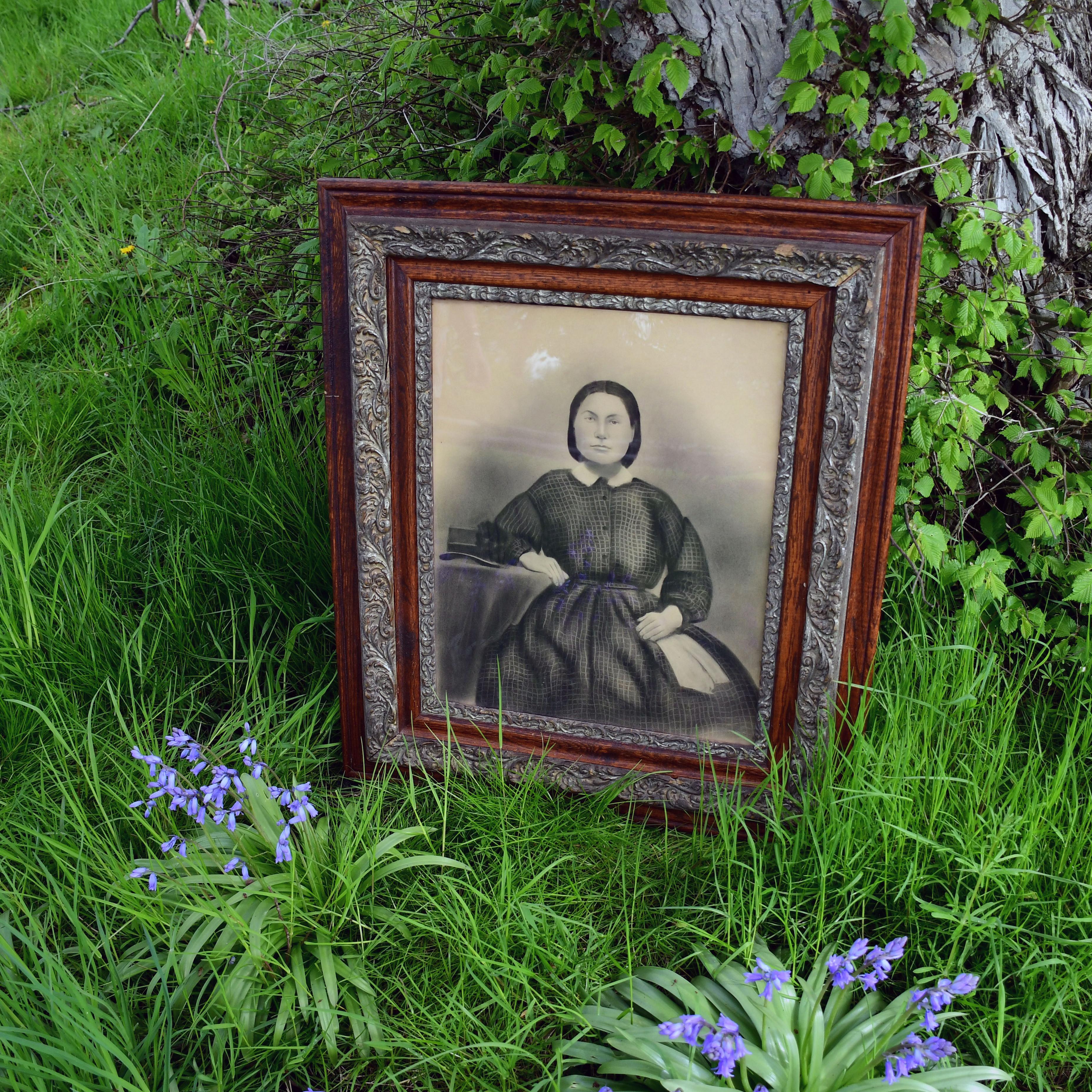 Historic portrait of Anna Pike Rosler, sitting in front of elm tree she planted