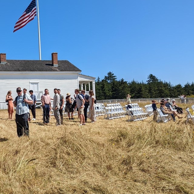 A wedding gathers at outside a historic building