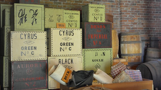Wooden storage boxes of various colors and sizes for items such as coffee and tea.