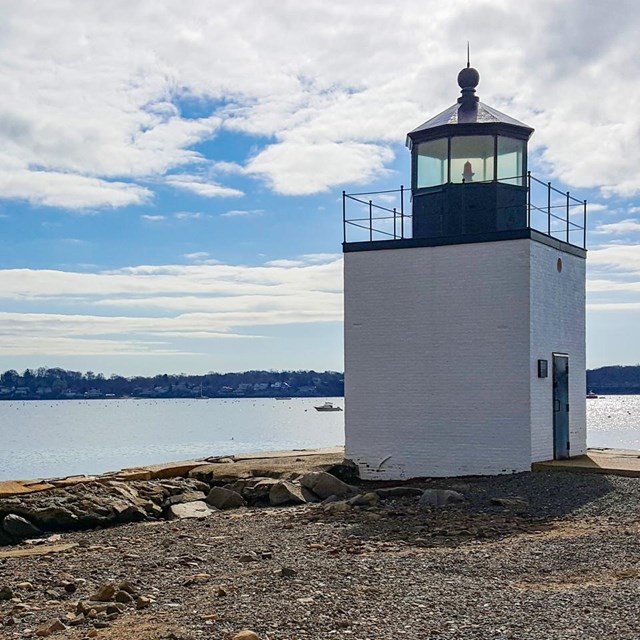 light house on the edge of the water