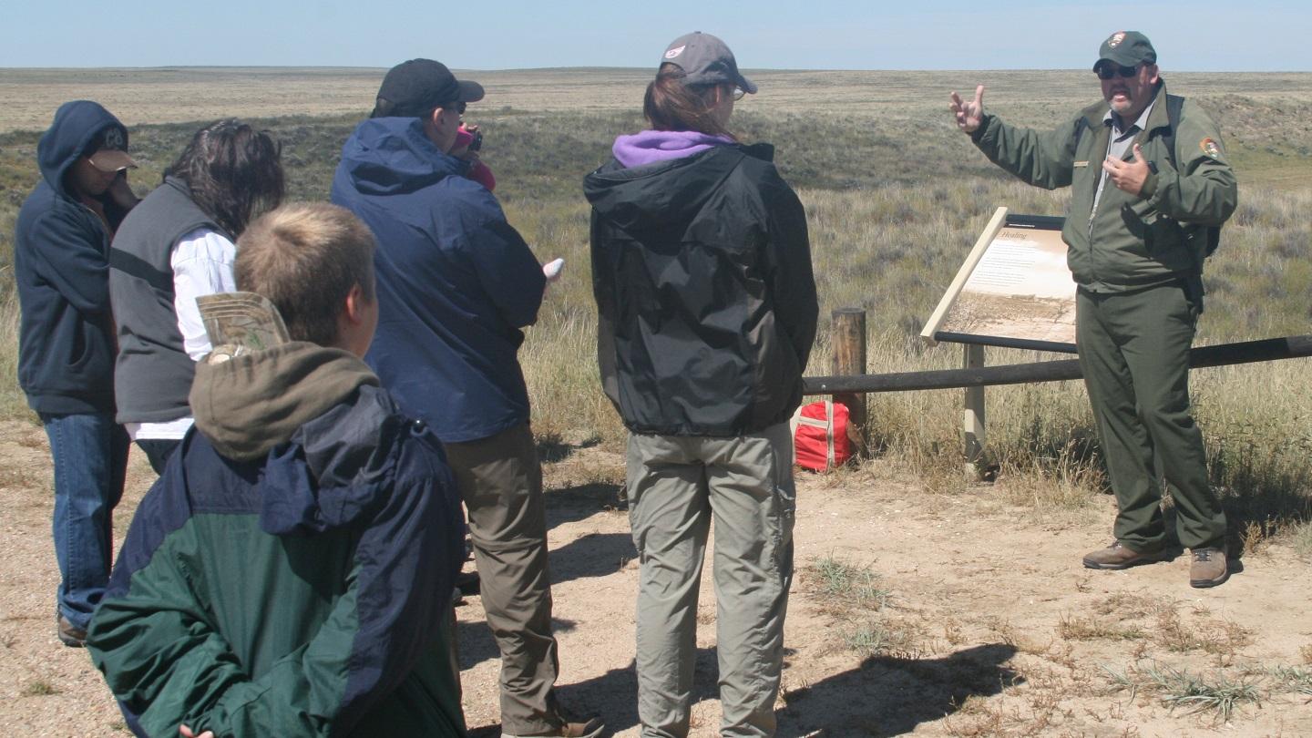 A ranger leads a tour for a small group
