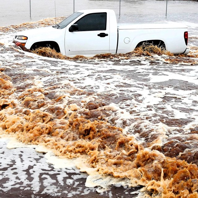 A Pickup Truck being swept away by flooding