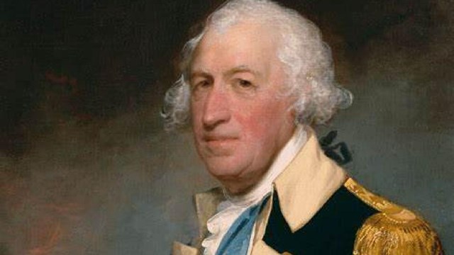 A man in an 18th century uniform with a white shirt, blue jacket with gold details, and blue sash.