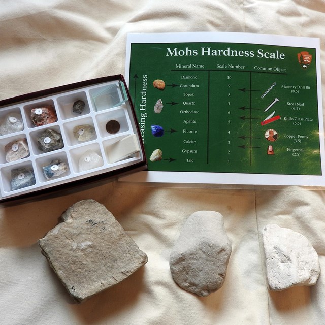 Rocks are spread on a canvas next to a chart labeled 