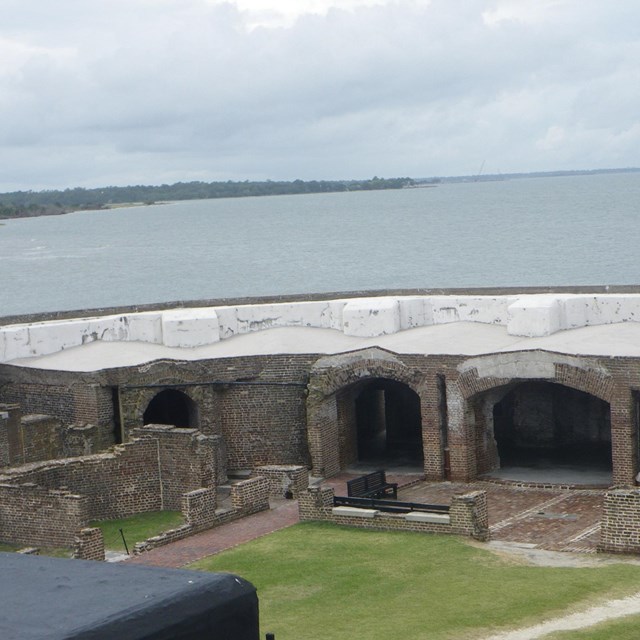 Inside of a fort with water in the background
