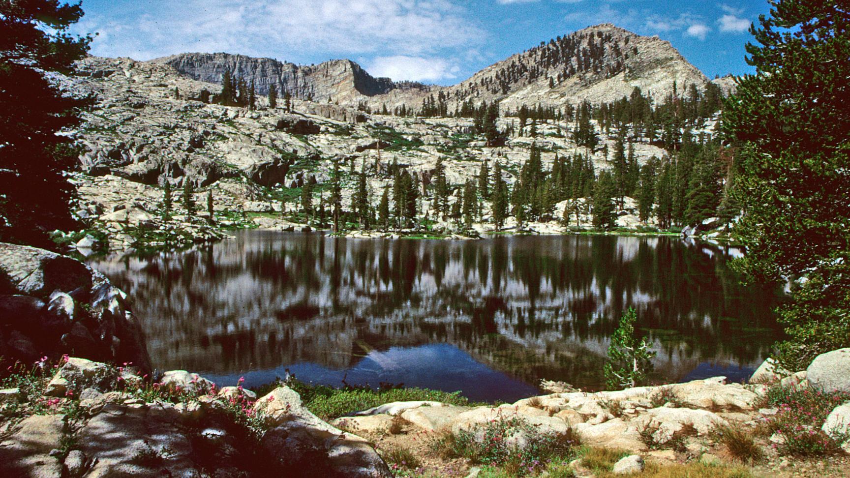 An alpine lake backed by large granite walls.