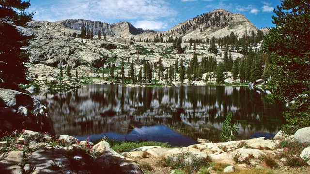 An alpine lake backed by large granite walls.