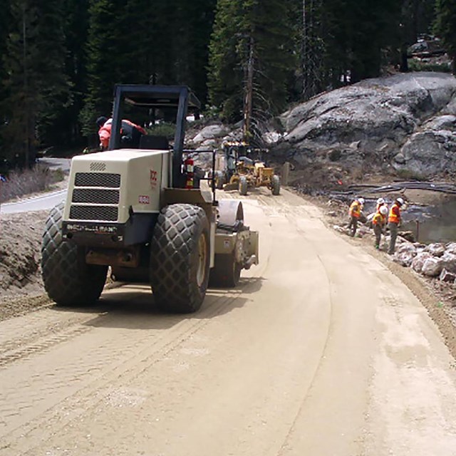 Heavy equipment works on resurfacing a road.