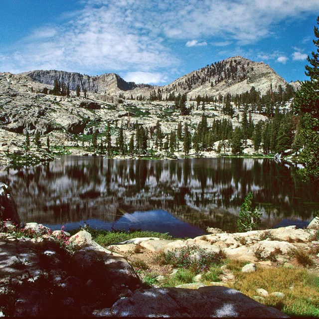An alpine lake backed by large granite walls.