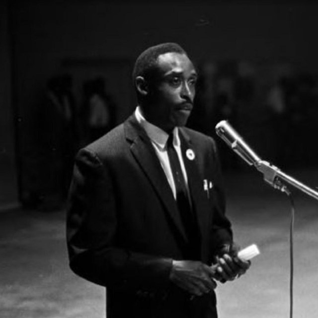 Newspaper article with a black and white photo of a middle-aged Black man.