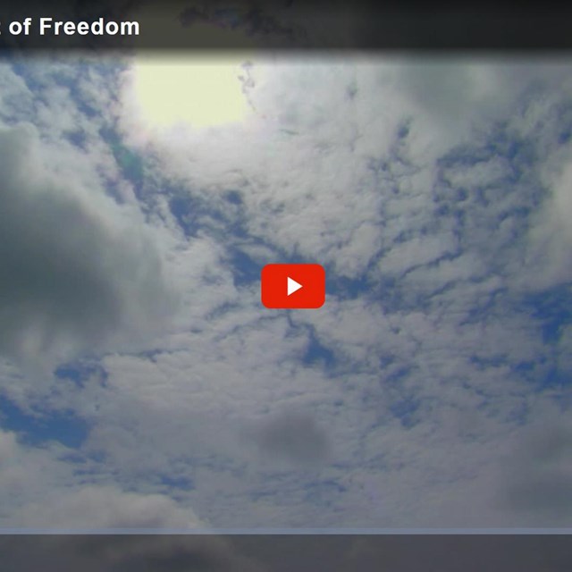 The paused title screen of a video with blue sky in the background.